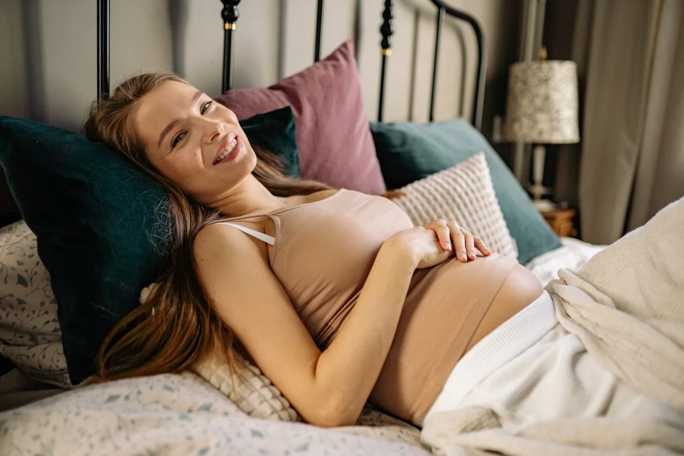 Smiling pregnant woman relaxing at home