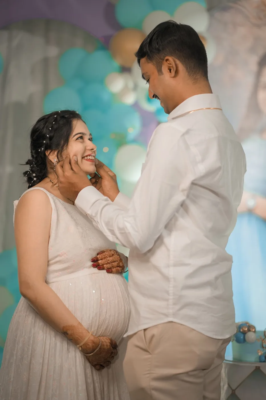 Pregnant woman laughing with her partner at a baby shower